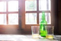 Green bottle of natural Cider with two traditional glasses windo Royalty Free Stock Photo