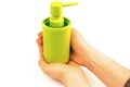 Green bottle packing of sanitizer, antiseptic with dispenser for sanitary soap, gel and detergent in female hands. Isolated on Royalty Free Stock Photo