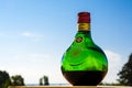 Green bottle of Unicum liqueur and blue sky