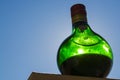 Green bottle of Unicum liqueur and blue sky