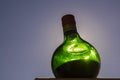 Green bottle of Unicum liqueur and blue sky