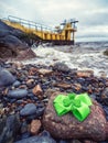 Green bow with shamrock on a rock by Blackrock diving tower, Salthill area, Galway city, Ireland. Popular city landmark and