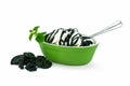 A green bowl with delicious vanilla ice cream, licorice sauce topping and mint. Licorice candy on the side. Royalty Free Stock Photo