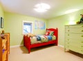 Green boys kids bedroom with red bed. Royalty Free Stock Photo