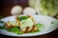 Green bread spread of arugula, curds and eggs with fried toast