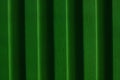 Green brick wall background.Grassy surface of colour building.