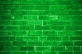 Green brick wall getting older from the bottom