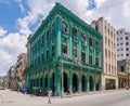 Green bright building in Havana Cuba surounded with people