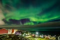 Green bright northern lights hidden by the clouds over the Inuit