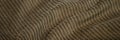 Green brown corduroy surface texture. Elegant background with space for design. Natural cotton ribbed fabric. Durable cloth. Dark Royalty Free Stock Photo