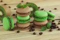 Green and brown french macarons with kiwi, coffee beans and mints decorations Royalty Free Stock Photo