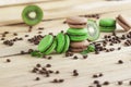 Green and brown french macarons with kiwi, coffee beans and mints decorations Royalty Free Stock Photo