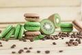 Green and brown french macarons with kiwi, coffee beans and mints decorations Royalty Free Stock Photo