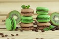 Green and brown french macarons with kiwi, coffee beans and mints decorations Royalty Free Stock Photo