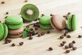 Green and brown french macarons with kiwi, coffee beans and mints decorations Royalty Free Stock Photo