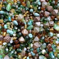 Green and brown glass beads mix for jewellery making. Hobby, handmade jewellery, fine arts. Beads texture. Close up Royalty Free Stock Photo