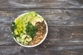 Green Buddha Bowl with lentils, quinoa, avocado, cucumber, fresh lettuce, herbs and seeds Royalty Free Stock Photo