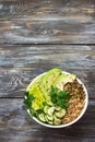 Green Buddha Bowl with lentils, quinoa, avocado, cucumber, fresh lettuce, herbs and seeds Royalty Free Stock Photo