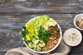 Green Buddha Bowl with lentils, quinoa, avocado, cucumber, fresh lettuce, herbs and seeds Royalty Free Stock Photo