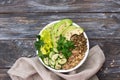 Green Buddha Bowl with lentils, quinoa, avocado, cucumber, fresh lettuce, herbs and seeds Royalty Free Stock Photo