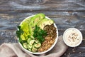 Green Buddha Bowl with lentils, quinoa, avocado, cucumber, fresh lettuce, herbs and seeds Royalty Free Stock Photo