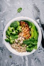 Green buddha bowl lunch with grilled chicken and quinoa, spinach, avocado, broccoli and white beans Royalty Free Stock Photo