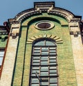 Green building with window historic building