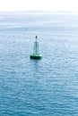 Green buoy floating in sea Royalty Free Stock Photo