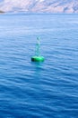 Green buoy floating in sea Royalty Free Stock Photo