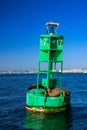 A green buoy with the number 17 on it sits in the water Royalty Free Stock Photo