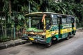 Green Bus wrackage ababdoned on side the street photo taken in Jakarta Indonesia