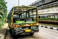 Green Bus wrackage abandoned on side the street near flyover bridge photo taken in Jakarta Indonesia