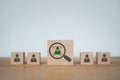 Green businessman and crop inside magnifying glass icon with blur others for leadership, smart employee, outstanding person