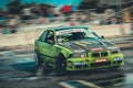 Green BWM racing car in action on wet asphalt Royalty Free Stock Photo