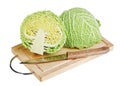 Green cabbage with knife on wooden chopping board