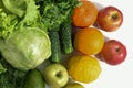 Green cabbage, parsley, cucumbers, salad, avocado, apple, orange orange, mandarin, yellow lemon, red apples on a white wooden Royalty Free Stock Photo