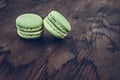 Green cake macaron on wood background, maccarone sweet dessert