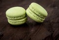 Green cake macaron on wood background, maccarone sweet dessert