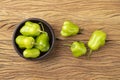 Green cambuci pepper, brazilian cuisine ingredient, on a bowl over wooden table