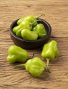 Green cambuci pepper, brazilian cuisine ingredient, on a bowl over wooden table
