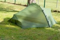 Green camping camp site tent in grass summer Royalty Free Stock Photo