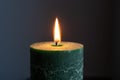 green candle flame burning in the dark