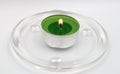 Green candle on glass suport