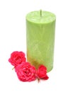 Green candle with pink flower rose isolated on a white Royalty Free Stock Photo