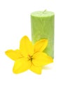 Green candle with yellow flower lily isolated on a white Royalty Free Stock Photo