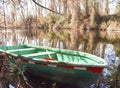 Green canoe morred to the shore Royalty Free Stock Photo