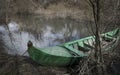 Green canoe parked in the shore of Alviela river next to Pombalinho Royalty Free Stock Photo