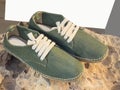 Green canvas summer shoes, with laces for men on a rock Royalty Free Stock Photo