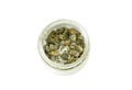 Green capers with coarse salt in a glass jar isolated on white background, top view. Salty vegetables spice culinary ingredient