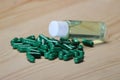 Green capsule with herbal oil in bottle Royalty Free Stock Photo